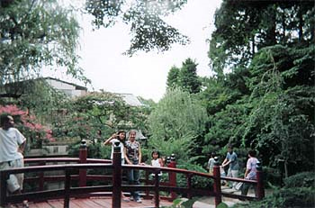 Brandi on a park bridge with host sisters