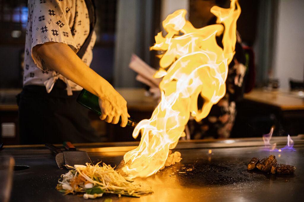 Tepanyaki - japanese grilled beef on pan. chef cooking at the hot table