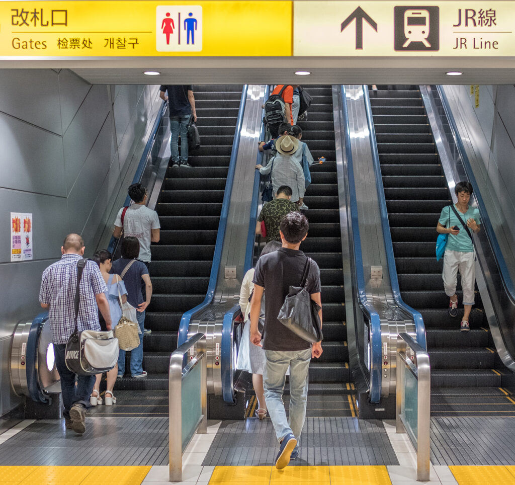 TOKYO, JAPAN - JULY 9TH, 2017. People riding elevator at Tokyo train station.